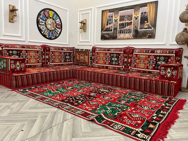 Cozy 8 inch L Shaped Arabic sofa set with red ethnic cushions and rug, perfect for Arabic Majlis living room decor.