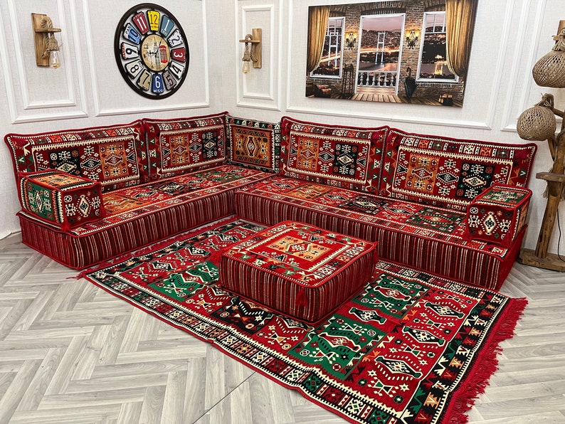 8 inch L Shaped Arabic sofa set with red ethnic floor cushions creating a cozy Majlis atmosphere in a living room.