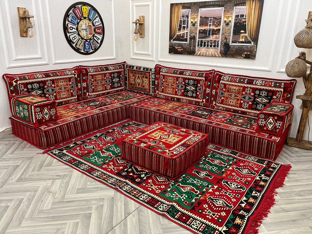 Cozy 8 inch L Shaped Arabic Sofa Set with red ethnic cushions and rug, perfect for a charming Arabic Majlis living room.