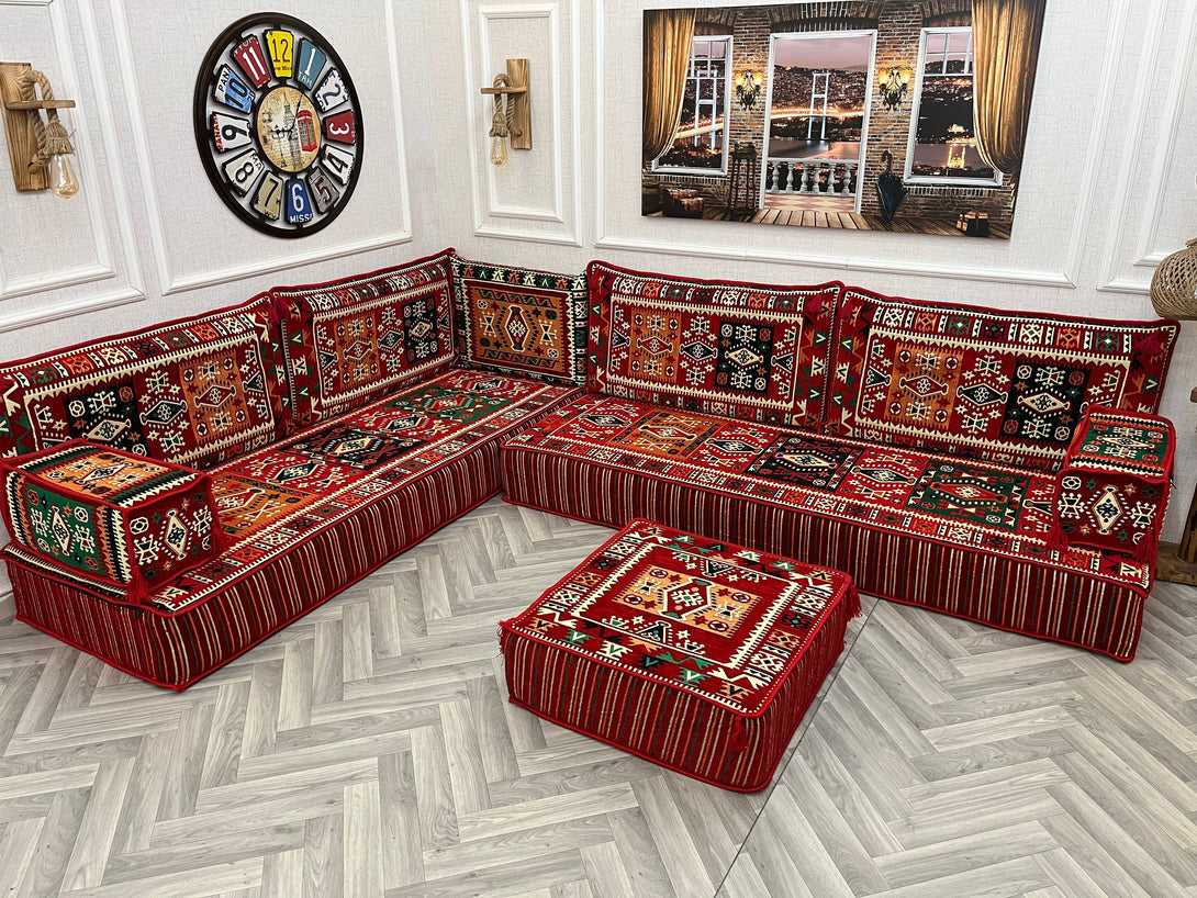 8 inch L Shaped Arabic Majlis Sofa Set in vibrant red ethnic design, featuring floor cushions and an ottoman for cozy seating.
