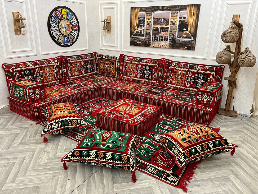 Cozy 8 inch L Shaped Arabic Majlis sofa set with red ethnic cushions and ottoman, ideal for inviting living room decor.